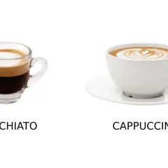 Macchiato i en liten glasbehållare bredvid en cappuccino i en vit kopp.