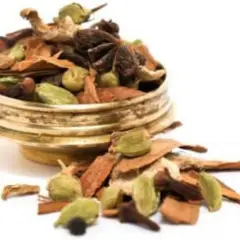En gyllene skål fylld med en aromatisk chai kryddblandning: kanel, kardemumma, stjärnanis och nejlikor.