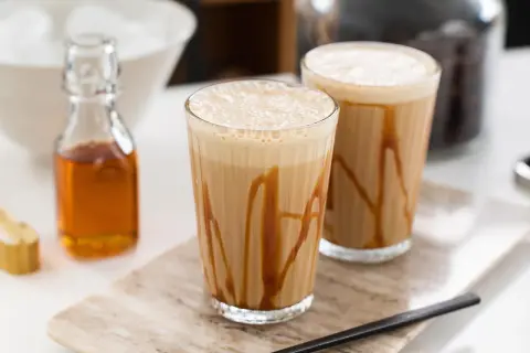 Två glas med karamellfrappe, redo att avnjutas. Ett enkelt frappe recept för en varm sommardag.
