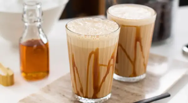 Två glas med karamellfrappe, redo att avnjutas. Ett enkelt frappe recept för en varm sommardag.